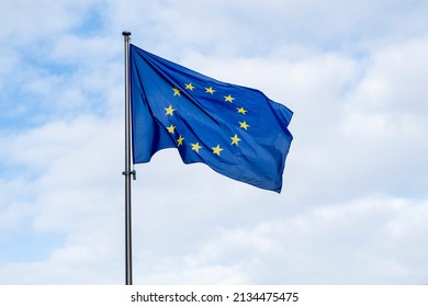 Panoramic view of a waving EU flag or European Union flag against blue sky	