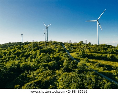 Similar – Image, Stock Photo Wind energy. Wind power. Sustainable, renewable energy. Wind turbine in clear blue sky generate electricity. Sustainable resources. Sustainable development. Green technology for energy sustainability.