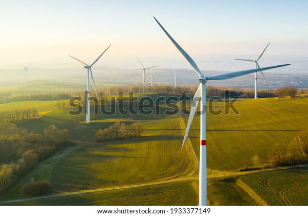 Panoramic view of wind farm or wind park, with\
high wind turbines for generation electricity with copy space.\
Green energy concept.