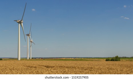 Panoramic view of wind turbines for electrical power generation in agricultural fields. Countryside in France. Renewable energy sources, industrial agriculture concept.   - Shutterstock ID 1519257905