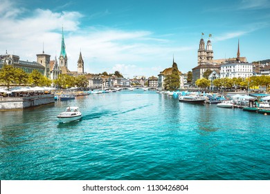 Panoramic view of Zurich city center with churches and boats on beautiful river Limmat in summer, Canton of Zurich, Switzerland