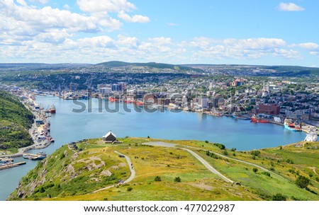 Panoramic views with bight blue summer day sky with puffy clouds over the harbor and city of St. John's NewFoundland, Canada. 