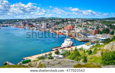Panoramic views with bight blue summer day sky with puffy clouds over the harbor and city of St. John's NewFoundland, Canada. 