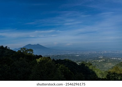 panoramic views of the lush, forested hillsides overlooking the sprawling city and the distant and impressive Mount Salak under clear blue skies. - Powered by Shutterstock