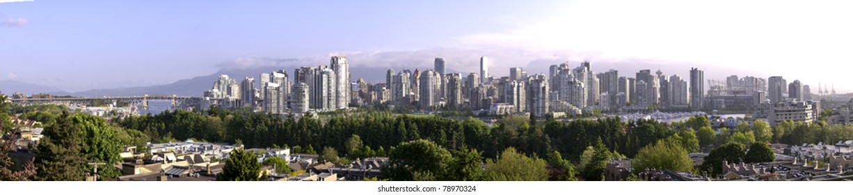 Panoramic water view of Vancouver from false creek. There is a light early morning mist.The roof is being built on B.C.Place.