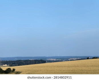Panoramic Wheat Fields beneath Blue Sky.

Wide panoramic view of golden wheat fields stretching toward the distant horizon.