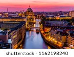 Panoromic  aerial view of Berlin skyline with famous TV tower and Spree river in beautiful post sunset twilight during blue hour at dusk with dramatic  colorful clouds , central Berlin Mitte, Germany