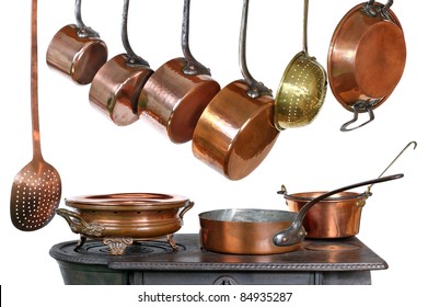 pans and kitchen utensils in copper