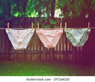 panties hanging on the line outside done with a retro vintage instagram filter 