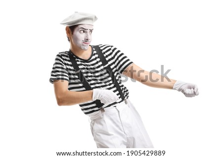 Pantomime man pulling an imaginary rope isolated on white background