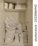 The pantry of a hotel is well stocked, it only contains the bare necessities, towels, toilet paper, towels and small items for the rooms as well as a bag for laundry