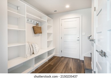 pantry and mudroom with white walls shelving hardwood floor - Shutterstock ID 2150235437