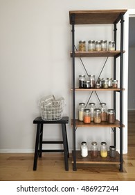 Pantry With A Rustic Industrial Shelving Unit With Various Glass Jars Filled With Kitchen Staples