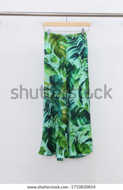 Pants with floral ,palm print, isolated\
on gray background\
\
\
