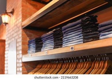 Pants Organized On Shelves, Casual Clothing Store, Wall Of Bricks