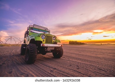 Paoay Sand Dunes, Paoay, Ilocos Norte, Philippines - September 2019: Adventure On A Lime Green 4x4 Off-road Jeep At The Sand Dunes