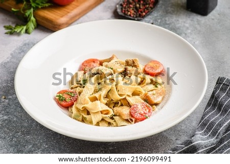 papardelle with porcini mushrooms and tomatoes. High quality photo