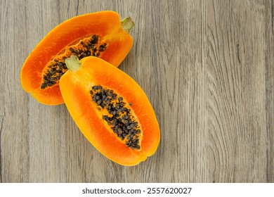 Papaya fruit on light wooden background. Slices of sweet papaya on wooden background, Halved papayas