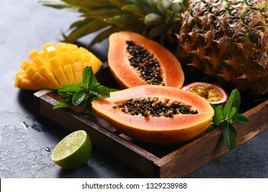 Papaya fruit, sweet ripe fresh papaya, mango, pine apple, raw vegan food, tropical fruits