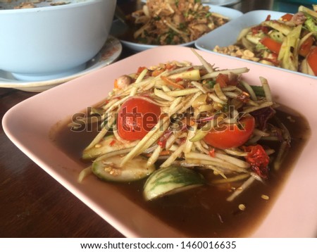 Papaya salad with crab in a white dish. Very appetizing