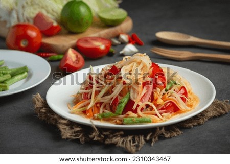Papaya salad is a food prepared from making papaya salad.  is to sour  In Laos, it is called Tam Mak Hung.  It is cooked mainly by pounding the chopped, sliced ​​or grated green papaya in a mortar.  A Zdjęcia stock © 