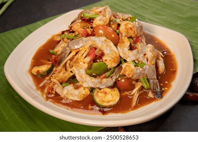 Papaya salad with Fresh raw shrimps prawns isolated on the Banana leaf, Khmer food decorations, spicy food - Powered by Shutterstock