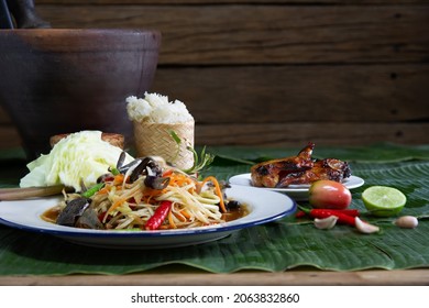 Papaya salad in white dish (Thai called Som tam) on fresh banana leaf,   Choose focus and free space for message.
 
 - Powered by Shutterstock