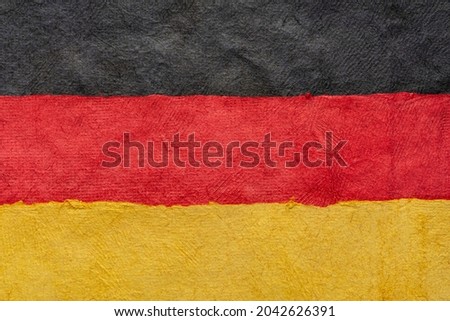 paper abstract in colors of Germany national flag - black, red and gold, set of textured, handmade, bark paper sheets
