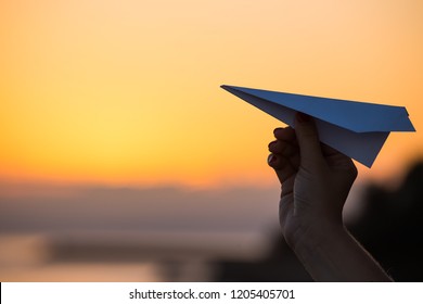 Paper Airplane Against The Sunset Sky