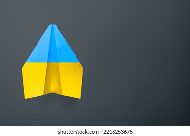 Paper Airplane Ukraine Flag Colors Background. Flight Along The Trajectory. Aid To Ukraine