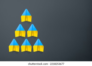 Paper Airplane Ukraine Flag Colors Background. Flight Along The Trajectory Behind The Leader. Aid To Ukraine