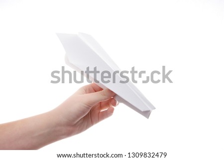 paper airplane in women's hands on white background