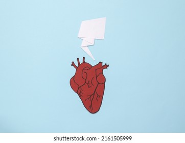 Paper Anatomical Heart With Dialog Bubble On A Blue Background. Heart Health Concept