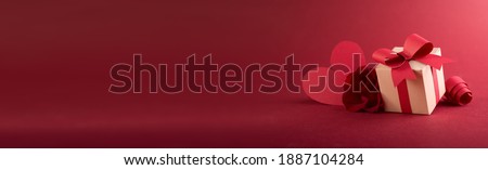 Paper art Valentine's day concept banner with hand made gift box, paper cut ribbon, bow, and a lot of hearts on a red background with space for text. Сток-фото © 