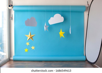 Paper Background For Birthday Baby Photoshoot. Blue Sky And Handmade Paper Cutting Stars.