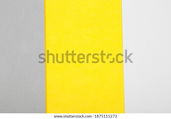 Paper background in two trendy colors\
- yellow and gray. Demonstrating colors of 2021\
year