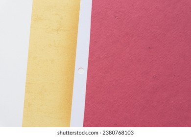 paper background with yellow and red elements and stripes with peg hole