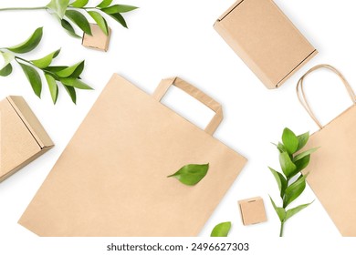 paper bag, cardboard boxes and green twigs with leaves on white isolated background, eco concept - Powered by Shutterstock