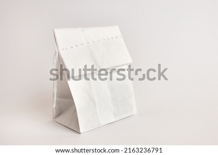 Paper bag with coffee beans, sewn with thread. Dry food packaging.