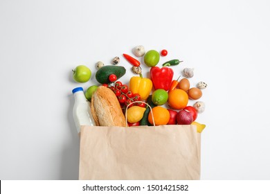 Paper Bag With Different Groceries On White Background, Top View