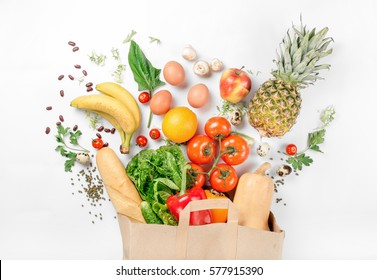 Paper bag of different health food on a white background. Top view. Flat lay - Shutterstock ID 577915390