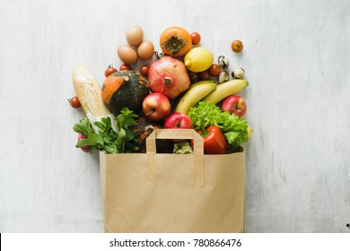 Paper bag of different health food on white wooden background. Top view. Flat lay - Shutterstock ID 780866476