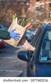 Paper Bag With Essential Supplies Given To Elderly Person At Food Distribution Point Queue