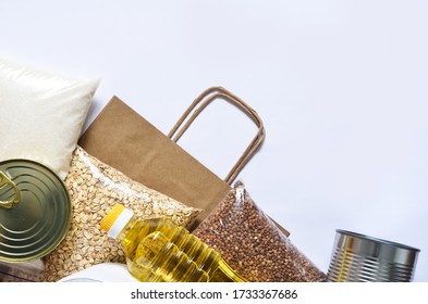 Paper bag with Food supplies crisis food stock for quarantine. Pasta, buckwheat, sugar, rice. Donation. Top view - Shutterstock ID 1733367686