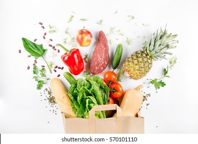 Paper bag full of healthy food on a white background. Top view. Flat lay - Shutterstock ID 570101110