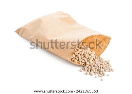 Paper bag with granular fertilizer isolated on white background [[stock_photo]] © 