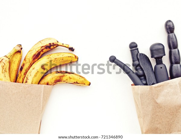 A Paper Bag With Ripe Yellow Bananas And A Paper Bag With Black Sex