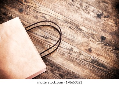 Paper bag rustic wooden background.