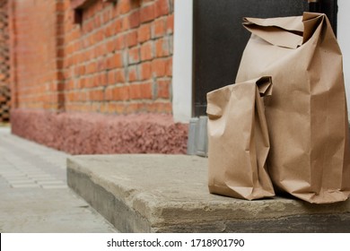 Paper Bag Takeaway Food Delivery On The Doorstep. The Concept Of Service Delivery. Space For Copying. Advertising Zone