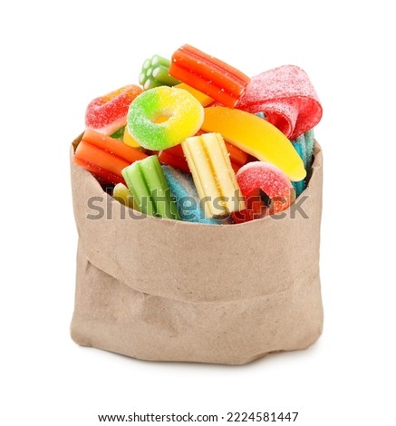 Paper bag of tasty colorful jelly candies on white background